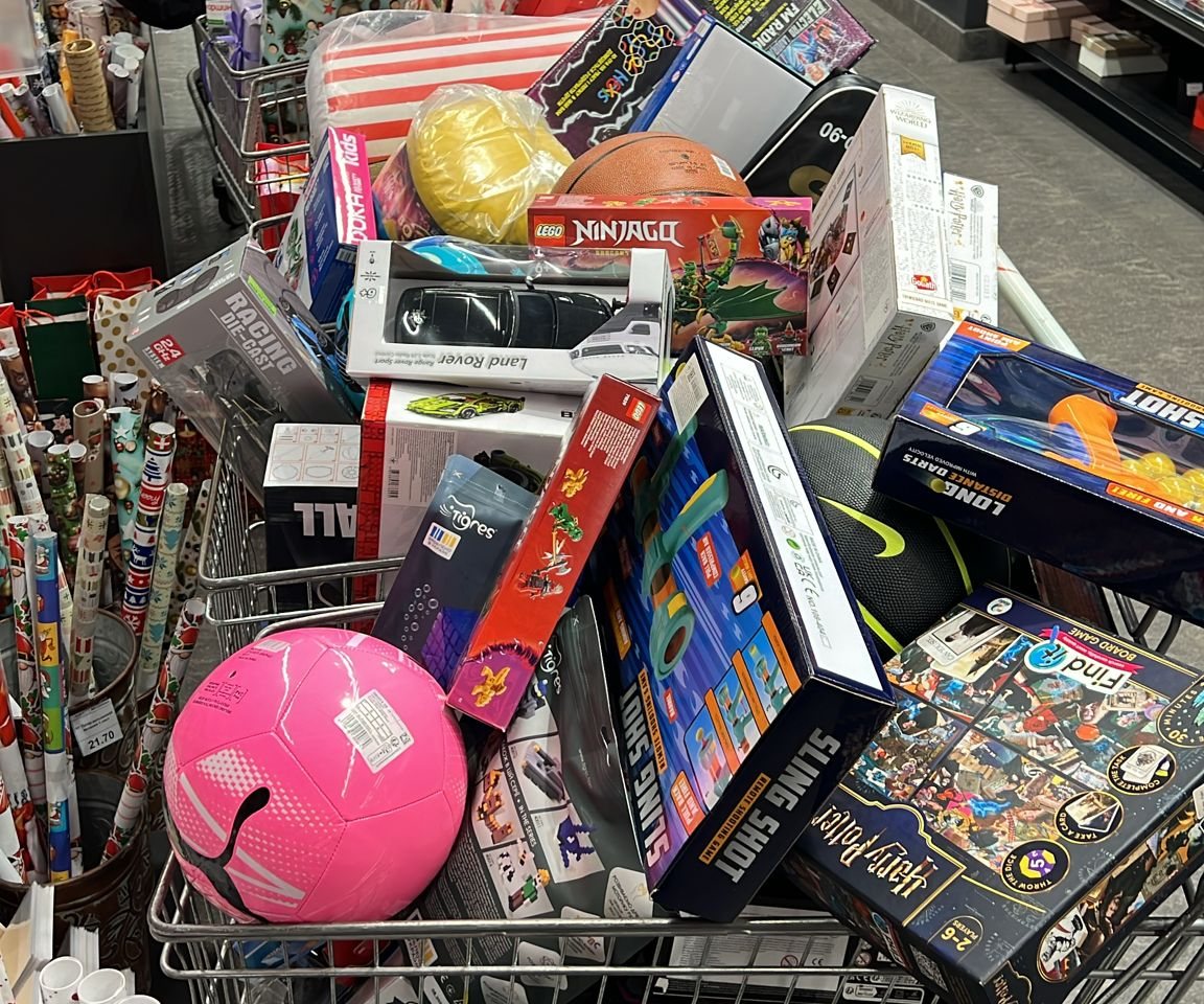 A shopping trolley piled high with toys and presents for the Christmas campaign
